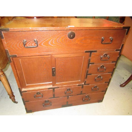 1962 - Japanese elm side cabinet, having iron mounts and handles, with arrangement of various drawers and s... 