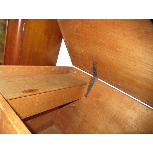 1971 - Stripped polished pine trunk, the hinged cover enclosing a candle box, raised on casters, 90cm wide ... 