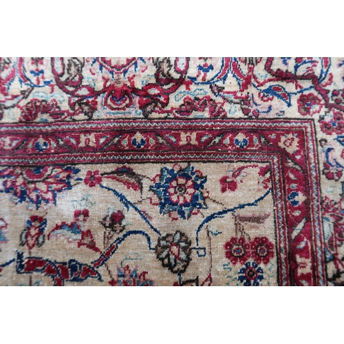 10 - Antique silk rug with all-over stylised floral design on an ivory ground with borders, possibly Isfa... 