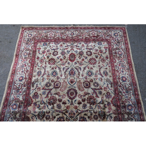 10 - Antique silk rug with all-over stylised floral design on an ivory ground with borders, possibly Isfa... 