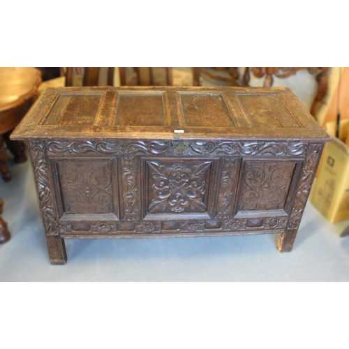 1598 - 17th Century oak coffer, the hinged four panel lid above a carved frieze and centre panel, flanked b... 