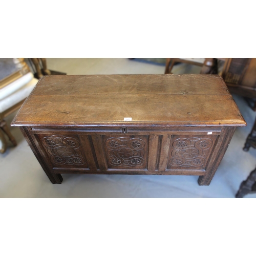 1601 - 17th Century oak coffer, the hinged moulded plank top above a carved three panel front on stile supp... 