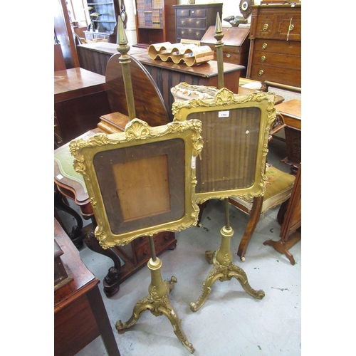 1765 - Pair of Victorian giltwood and ghesso firescreens on tripod bases, 138cm high