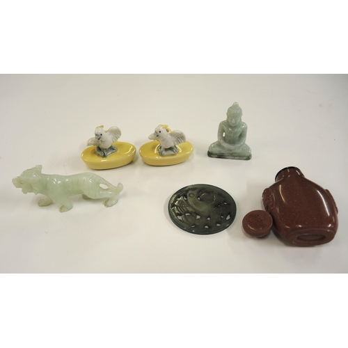 195A - Carved jade figure of a lion, another of a Buddha, a pierced jade disc carved with a figure of a bir... 