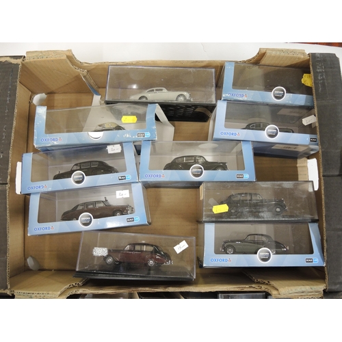 243 - Two boxes containing a quantity of various display model vehicles and a quantity of boxed Oxford 1:4... 