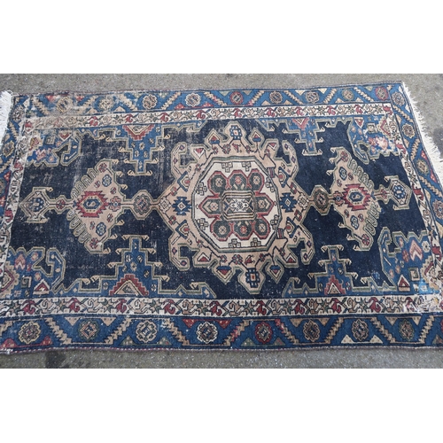 25 - Shiraz rug with multiple geometric patterns on a red ground, together with a Hamadan rug on blue gro... 