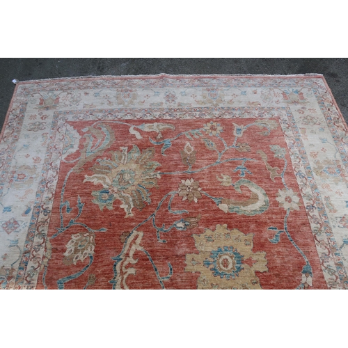 28 - Good quality Indo-Persian carpet of Ziegler design, with stylised palmettes on a brick red ground wi... 