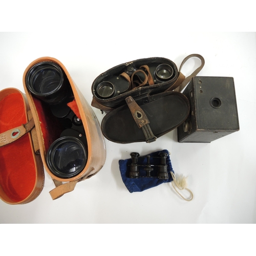 309 - Two pairs of leather cased binoculars, camera and a pair of opera glasses