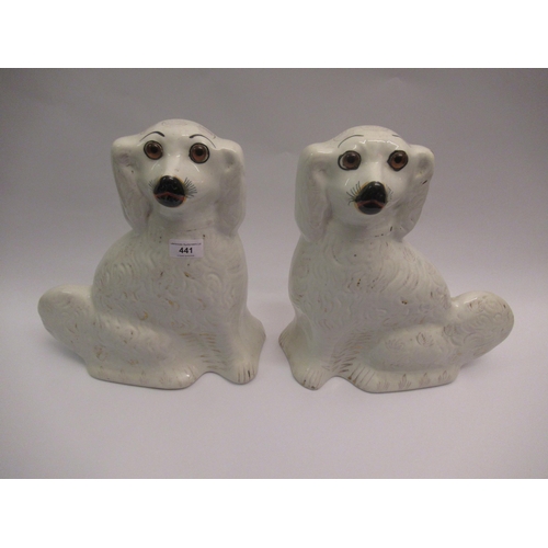 441 - Pair of Staffordshire pottery figures of seated Spaniels with glass eyes, 33cm high