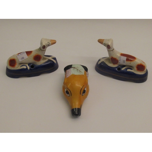 480 - Reproduction porcelain stirrup cup in the form of greyhound head, together with a pair of greyhound ... 