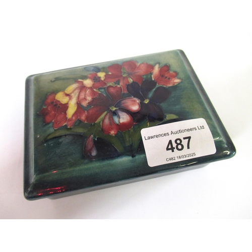 487 - Moorcroft rectangular box and cover decorated with flowers on a blue/green ground, 12cm x 10cm