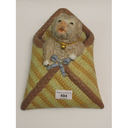 494 - French porcelain wall pocket mounted with a figure of a dog, 26cm high