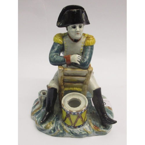 505 - Continental pottery figure of Napoleon seated before a drum, 21cm high