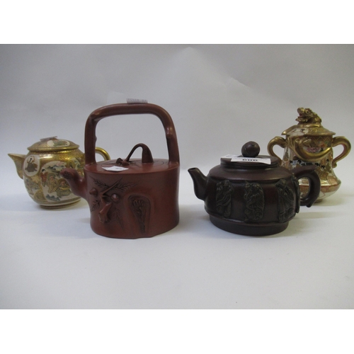 606 - Two Chinese terracotta teapots, together with two items of Japanese Satsuma pottery (at fault)