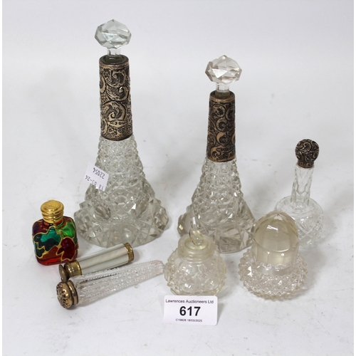 617 - Four various silver mounted cut glass perfume bottles, together with four other bottles