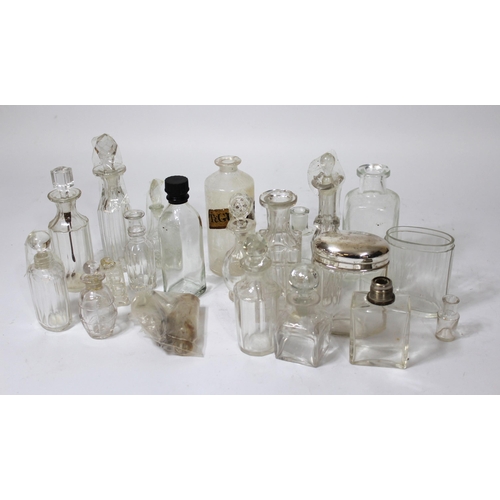 643 - Three small boxes containing a collection of silver topped cut glass dressing table and perfume bott... 