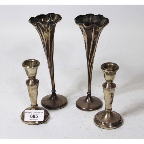 685 - Pair of small modern silver candlesticks (filled), together with a pair of silver specimen vases (we... 