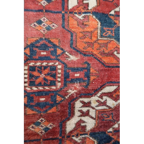 7 - Tekke carpet with five rows of eleven gols on a red ground with borders, 285 x 200cm