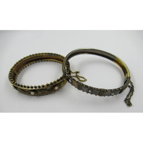 770 - Two Victorian yellow metal pearl set bangles, 30g