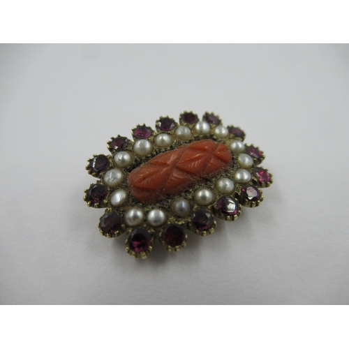 772 - Small Georgian oval yellow metal brooch set carved coral, seed pearls and garnets, 21mm x 15mm