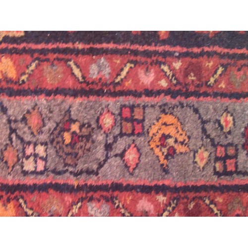 19 - Hamadan runner with an all-over stylised floral design on a dark ground with borders, some wear, 290... 