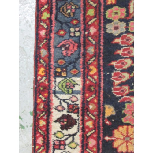 19 - Hamadan runner with an all-over stylised floral design on a dark ground with borders, some wear, 290... 