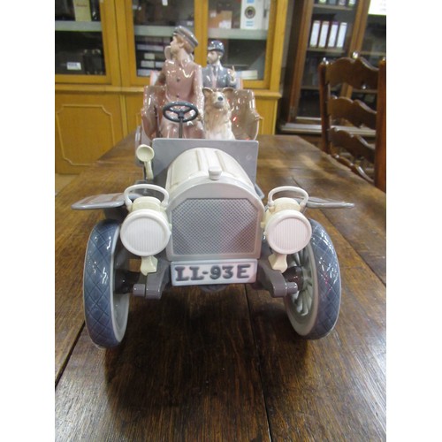 452 - Large Lladro model of a veteran car with driver, passengers and dog on original wooden base, 65cm wi... 