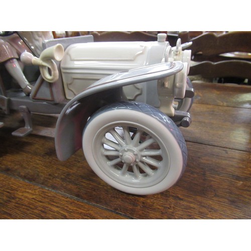 452 - Large Lladro model of a veteran car with driver, passengers and dog on original wooden base, 65cm wi... 