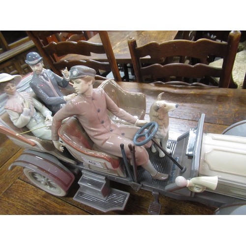 452 - Large Lladro model of a veteran car with driver, passengers and dog on original wooden base, 65cm wi... 