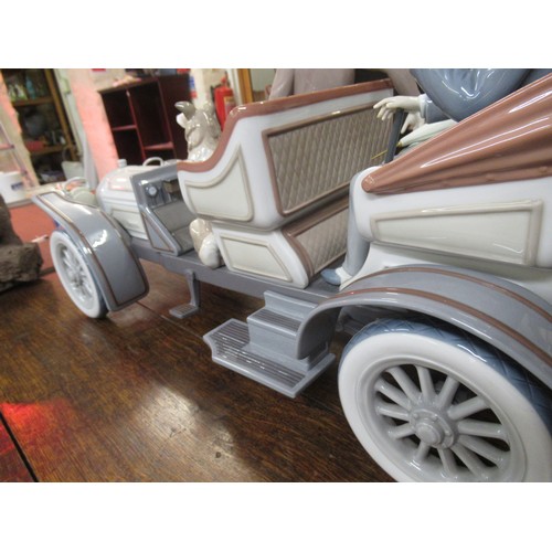 452 - Large Lladro model of a veteran car with driver, passengers and dog on original wooden base, 65cm wi... 