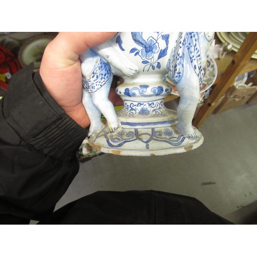 499 - Antique Delft pottery tulip vase on three cherub supports, 27cm high (with damages)