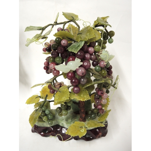 335 - Modern green and purple jadeite carving of a grapevine, on a hardwood stand, 28cm high