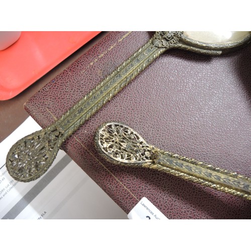 299 - Cased gilt metal dressing table set, together with another similar