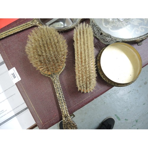 299 - Cased gilt metal dressing table set, together with another similar