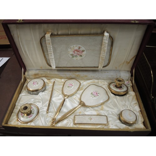 299 - Cased gilt metal dressing table set, together with another similar