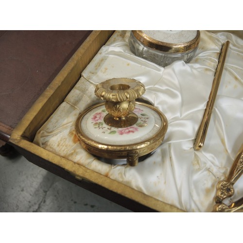 299 - Cased gilt metal dressing table set, together with another similar