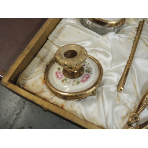 299 - Cased gilt metal dressing table set, together with another similar