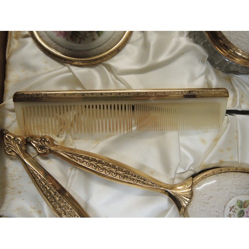299 - Cased gilt metal dressing table set, together with another similar