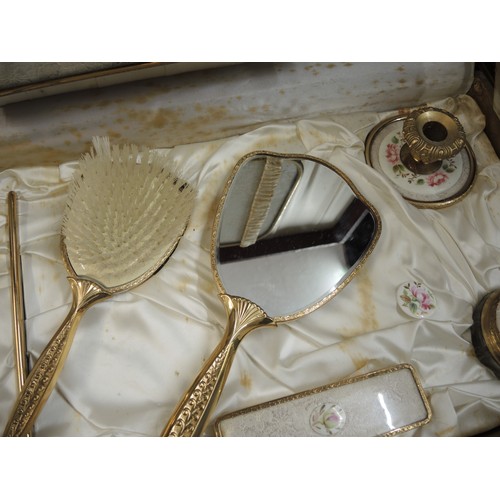 299 - Cased gilt metal dressing table set, together with another similar