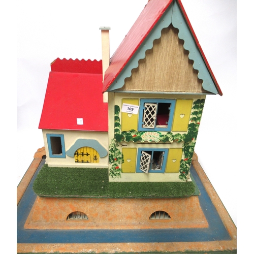 109 - Painted wooden doll's house together with two cricket bats, a hockey stick and three walking canes