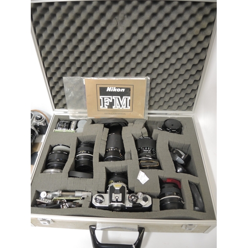 125 - Nikon camera outfit including FM and FE bodies, with various Nikon and other lenses