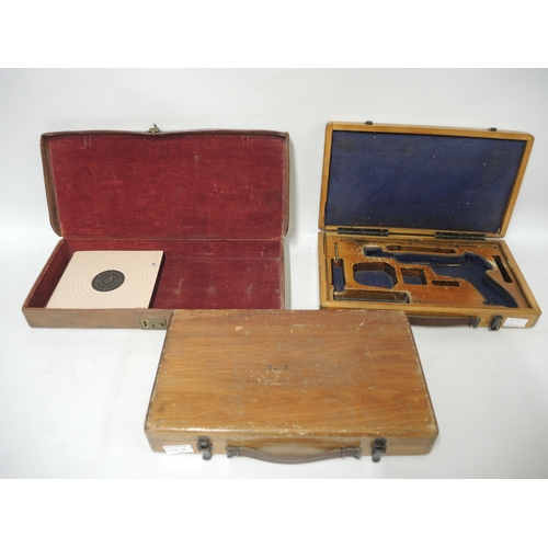 143 - Early 19th Century brown leather pistol case with targets, together with two wooden pistol cases