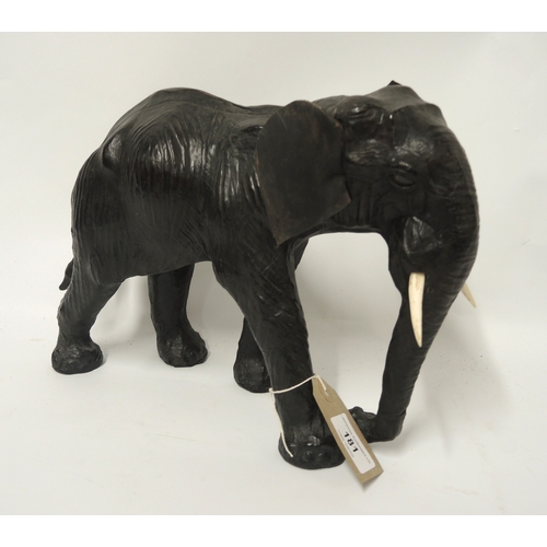 181 - Liberty type leather covered figure of an elephant, 32cm long