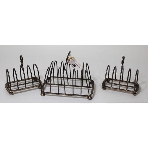 560 - Early 19th Century silver six division toast rack (at fault), together with a pair of similar later ... 