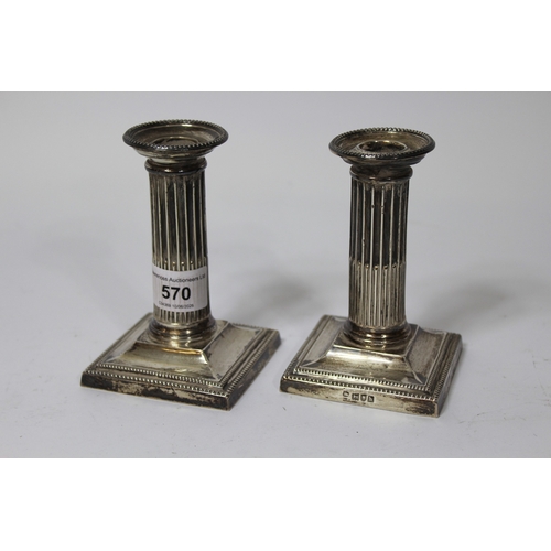 570 - Pair of early 20th Century London silver dwarf candlesticks (weighted)