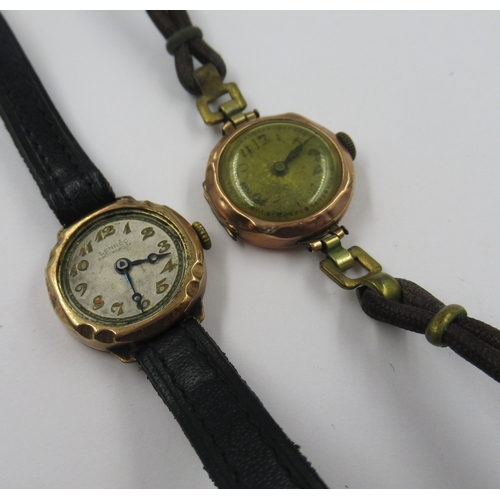 595 - 9ct Gold ladies wristwatch with leather strap, together with a similar ladies wristwatch