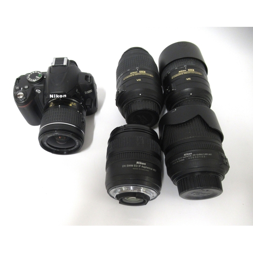79 - Two Nikon 55-300mm DX lenses, 18/70, 18/105 and D3000 bodies with another lens and various chargers