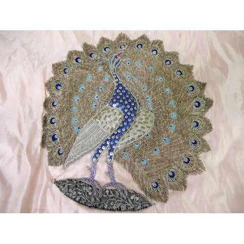 105 - Embroidered peach silk panel of two peacocks in silver and gold thread, unframed