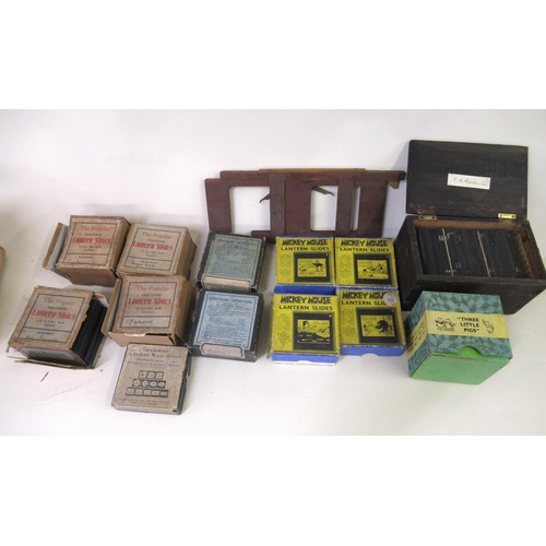 220 - Late 19th Century black Japanned and brass magic lantern in original tin case, together with a quant... 