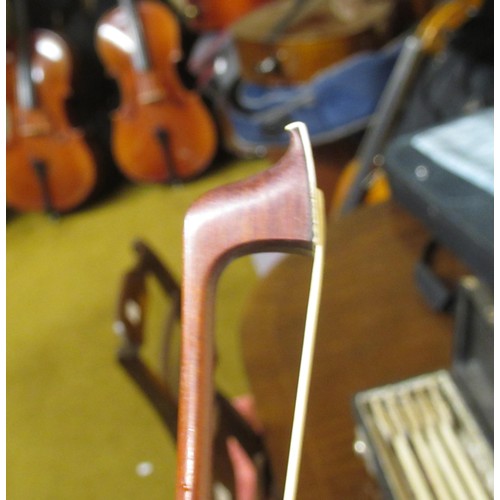 198 - Case containing a collection of six various violin bows including one signed Arnold, Paris